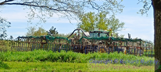 A tractor spreading muck