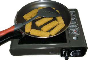 Making salmon fish fingers on the mini gas cooker.