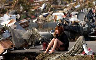 Natori, a woman alone in the wreckage, crying.