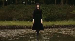 Screen capture from Fatal Frame showing a girl in school uniform walking on a pond. And I mean 'on'.