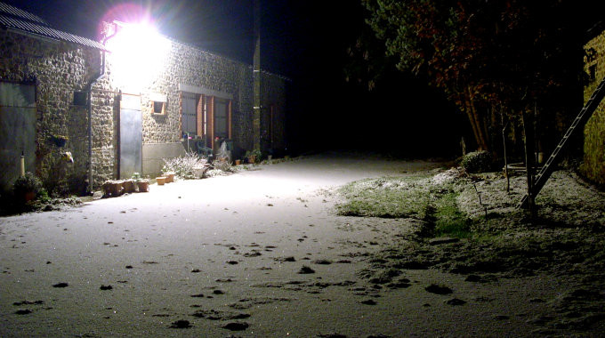 Long exposure night photo of snow out front.
