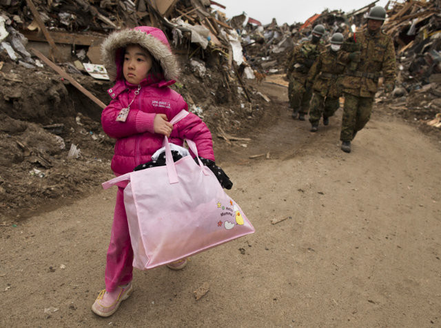 Neena Sasaki, carrying salvaged things from what was left of her family's home.