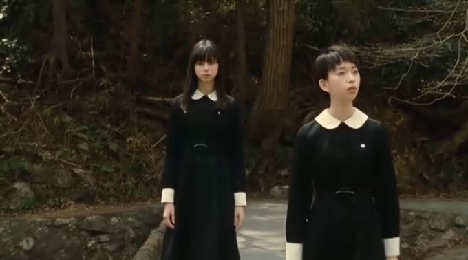Screen capture from Fatal Frame showing two girls in school uniform on a bridge, and even in daylight it manages to be spooky.