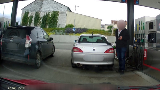A dashcam shot of some bloke failing at filling his car